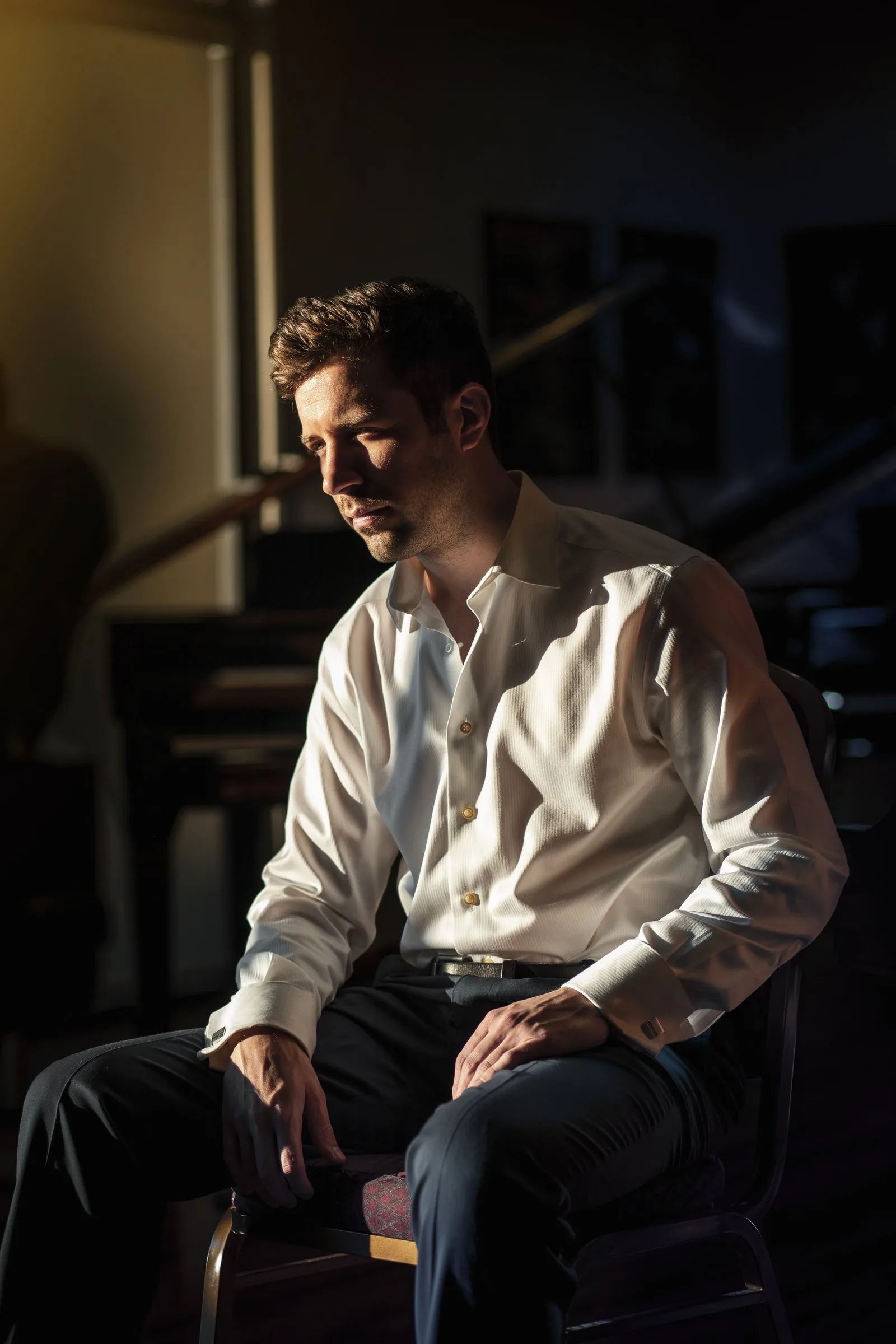 Dr. Michael Guida seated in his piano studio