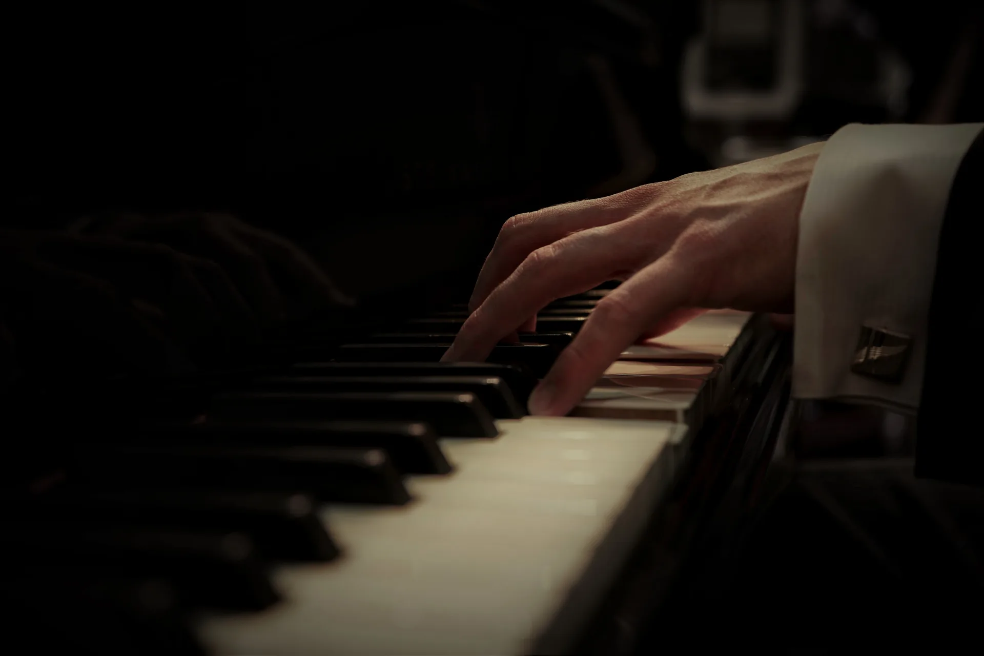 Close-up of hands playing the piano keys