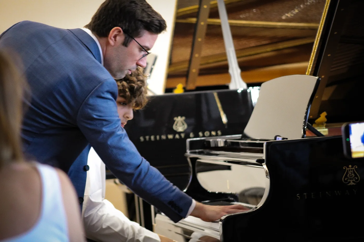 Dr. Guida demonstrating at the keyboard with Avery
