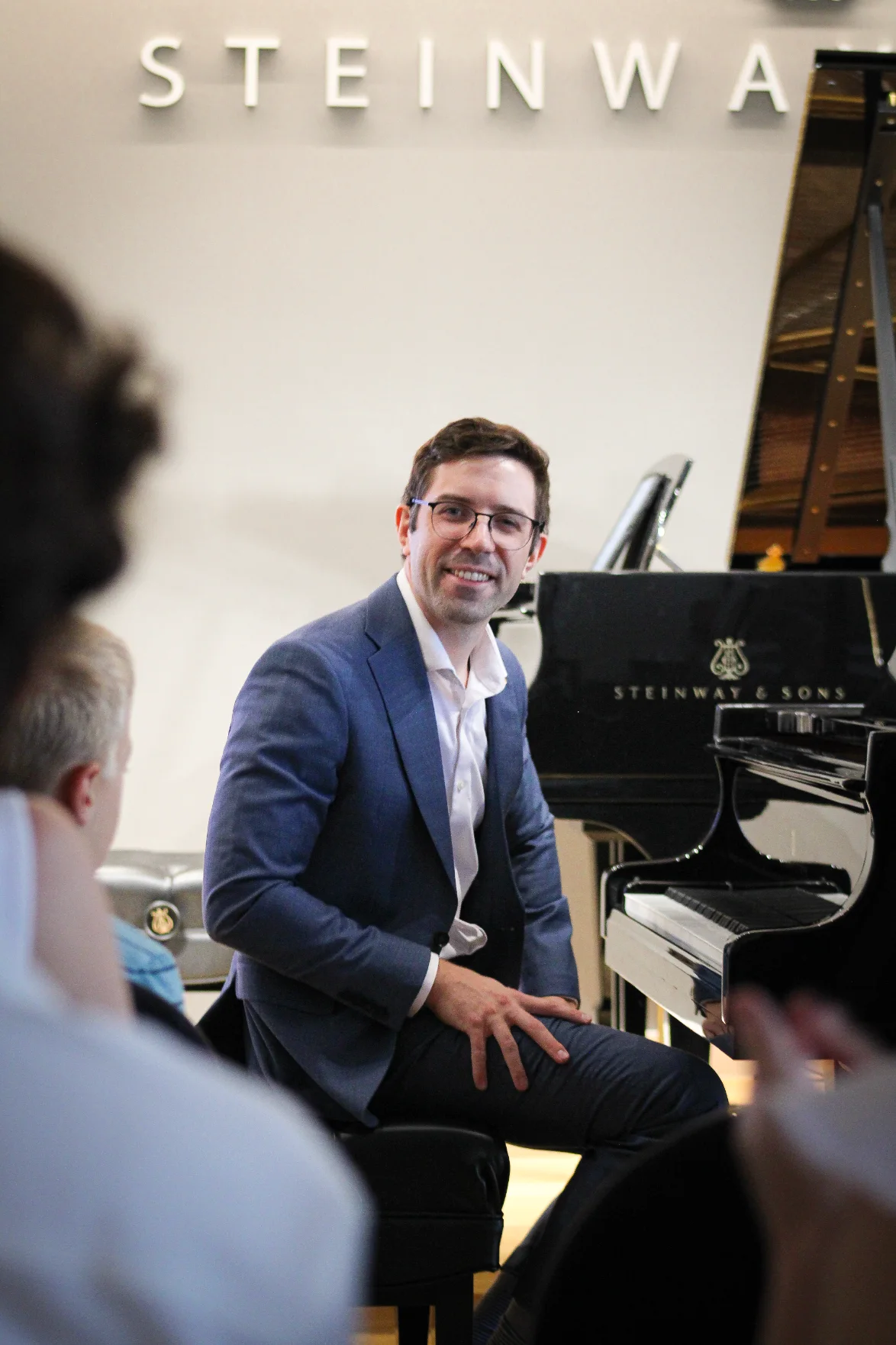 Dr. Michael Guida seated at the piano during the event