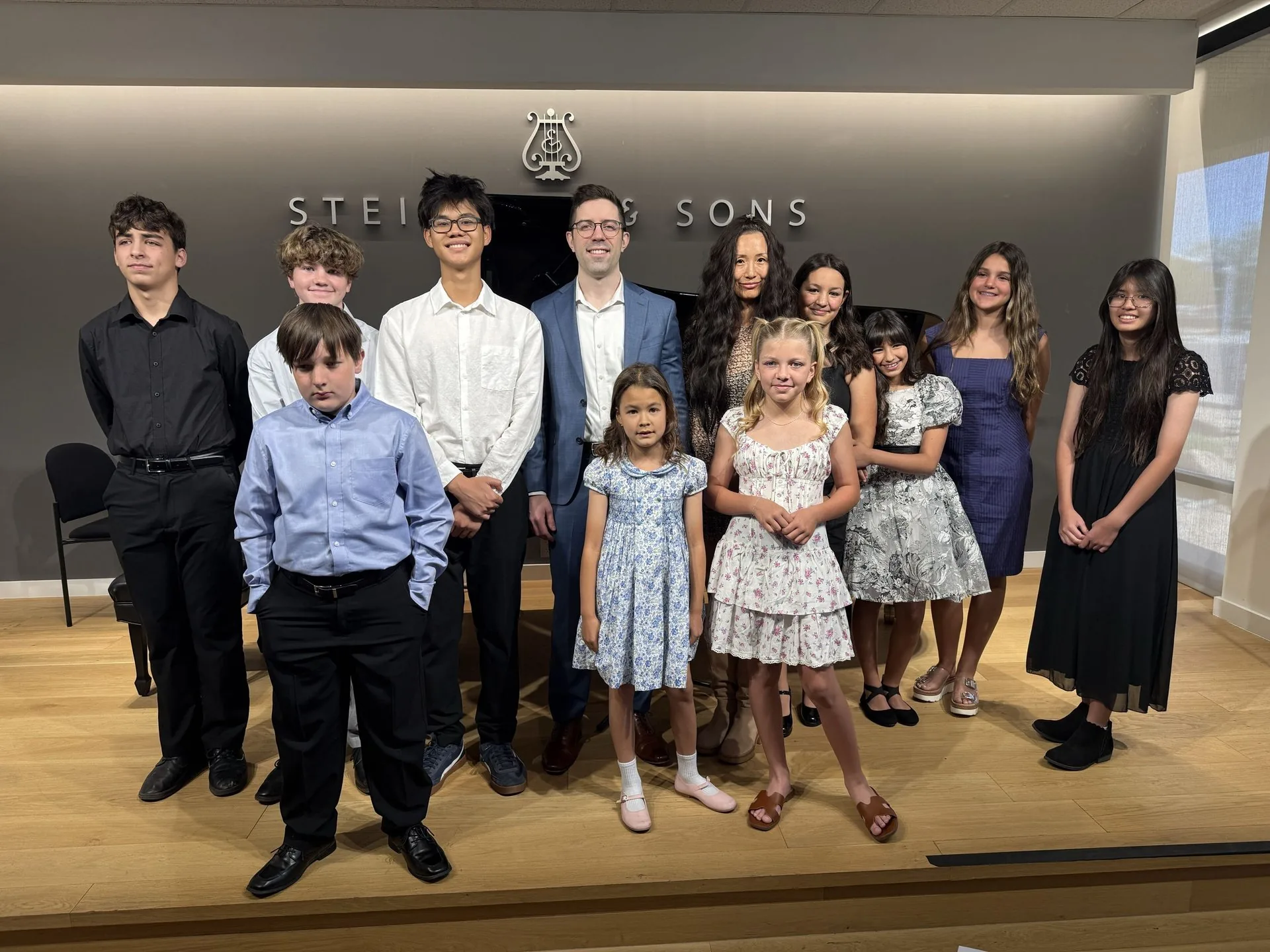 Dr. Michael Guida with piano students at a studio recital